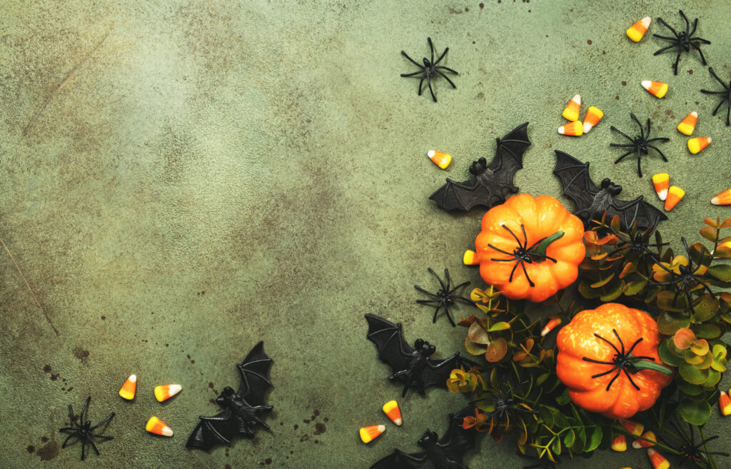 Happy Halloween swamp green background with pumpkins, bats, spiders, candy corn