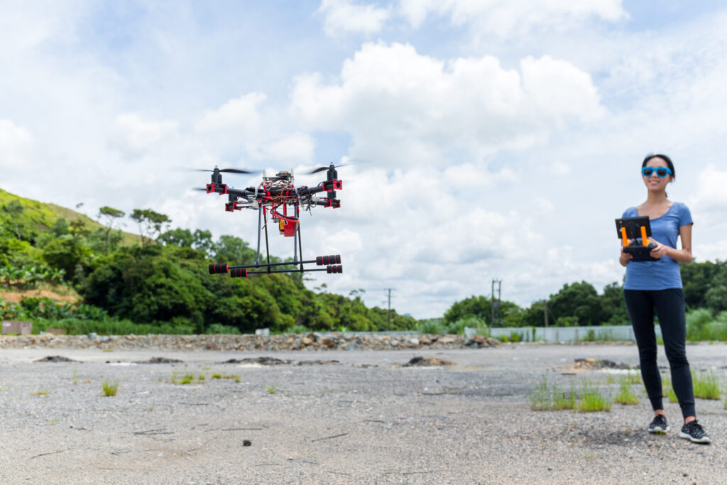 Young woman control Drone flying at outdoor